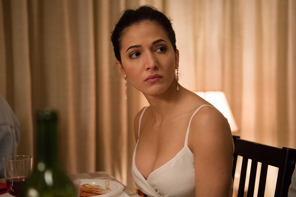 0z6a8945-maggie-naouri-as-anu-singh-listens-to-somoene-offscreen-at-the-dinner-party