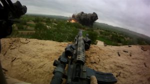 Daneh Pasab, Afghanistan: An enemy location explodes in the distance. (Photo Credit: National Geographic Channels/ Mark Terrell/ Michael Golembesky)